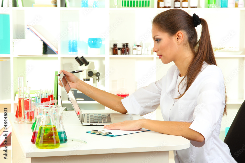 Young female scientist in laboratory. Young female scientist in laboratory.