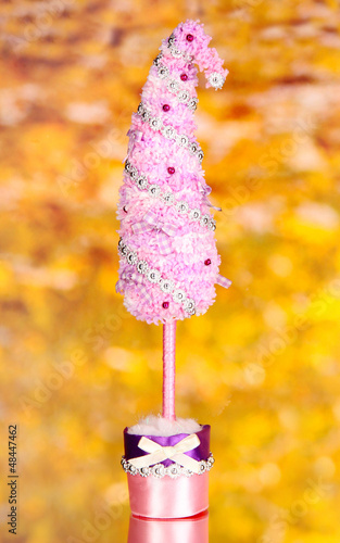 Christmas tree with curved tip on bright background © Africa Studio