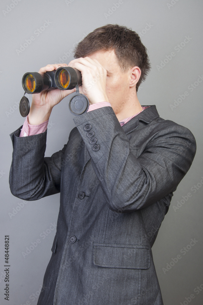 Businessmen looking through binocular Businessmen looking through binocular