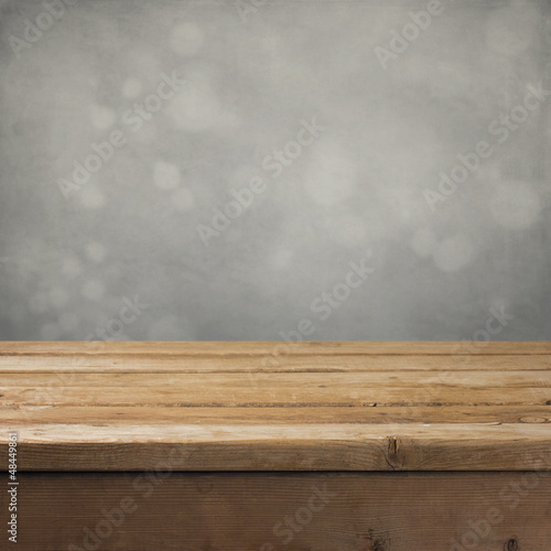 Retro background with wooden table and gray backdrop