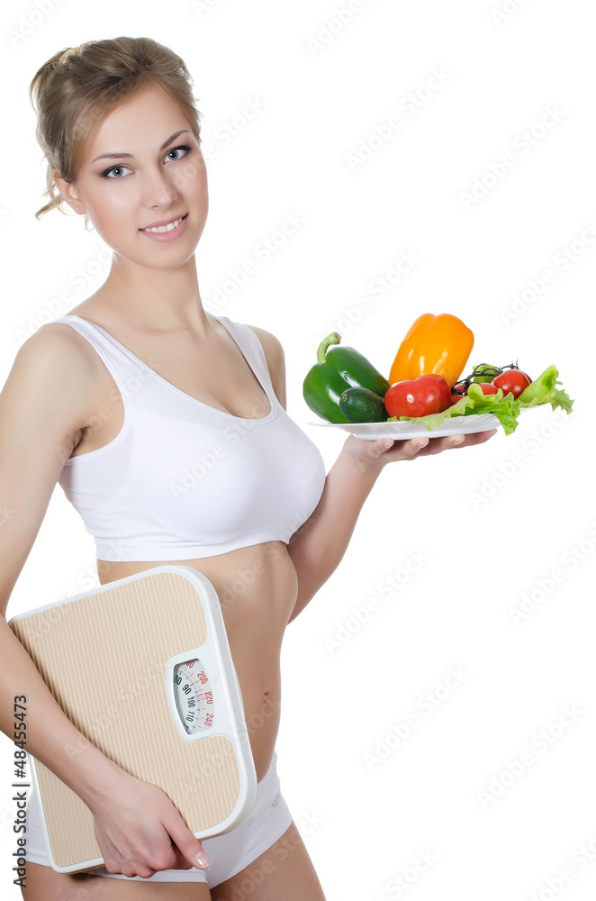 The beautiful girl with a plate with vegetables The beautiful girl with a plate with vegetables