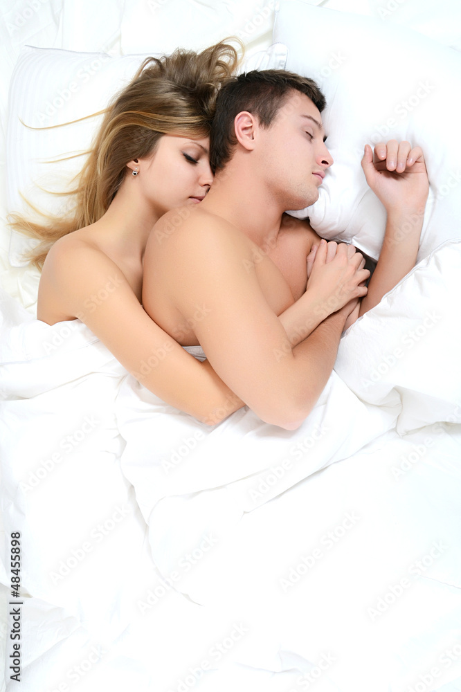 Beautiful pair lays in a bed Beautiful pair lays in a bed