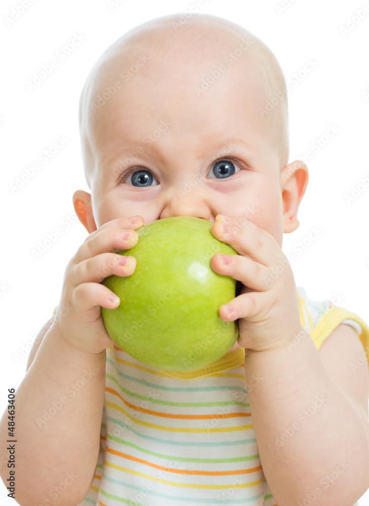 Baby boy holding and eating green apple, isolated on white Baby boy holding and eating green apple, isolated on white