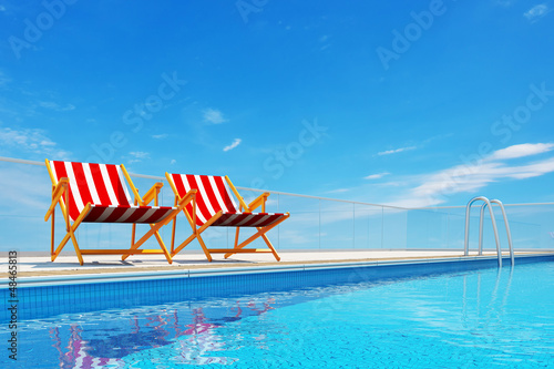 Swimming pool with beach chairs © ungureanusergiu