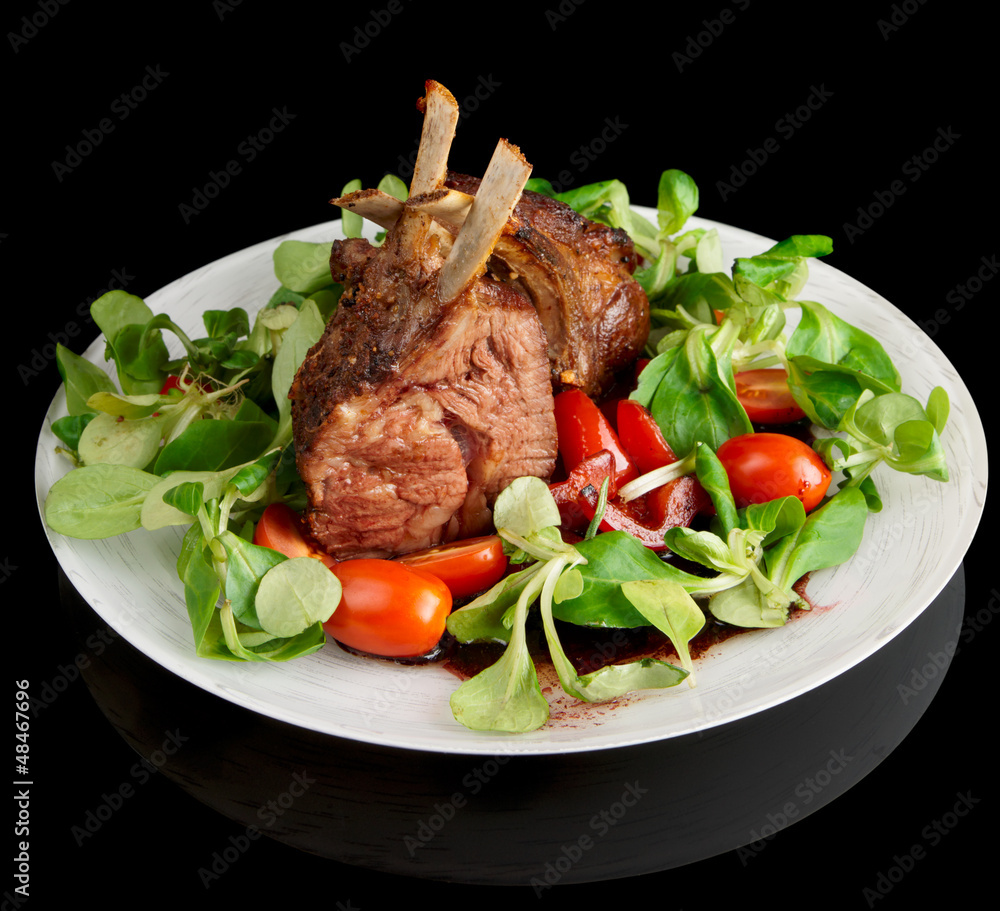Rare fried rack of lamb isolated on black