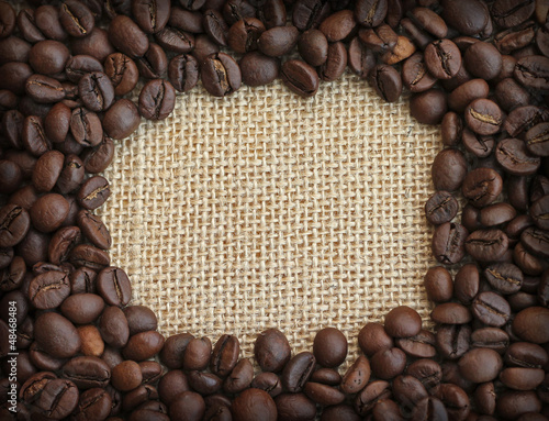 Frame of coffee beans on canvas background, close-up