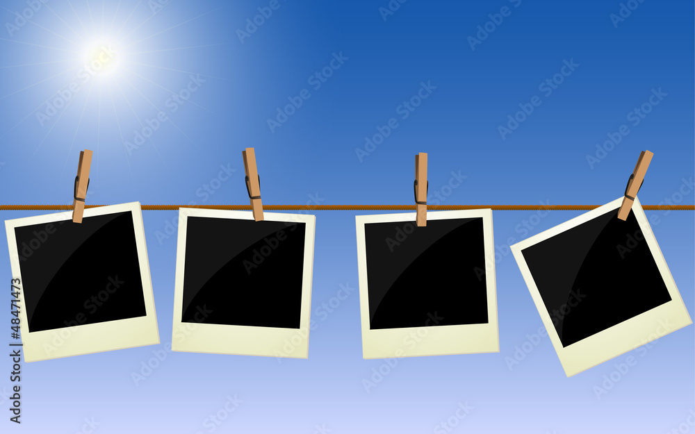 Four polaroid pictures hanging on rope against bright sky Four polaroid pictures hanging on rope against bright sky