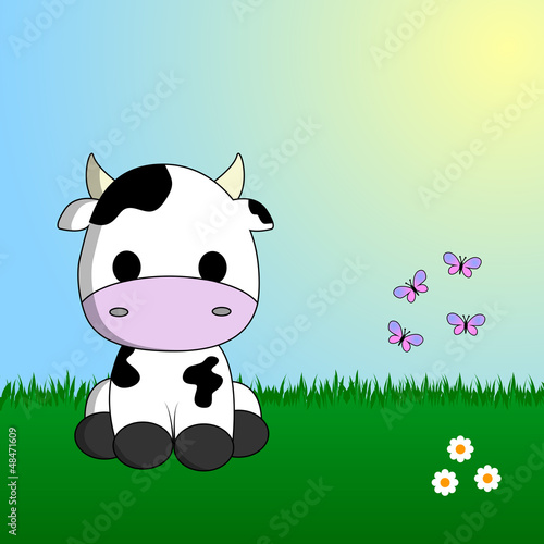 Cute cow sitting in grass