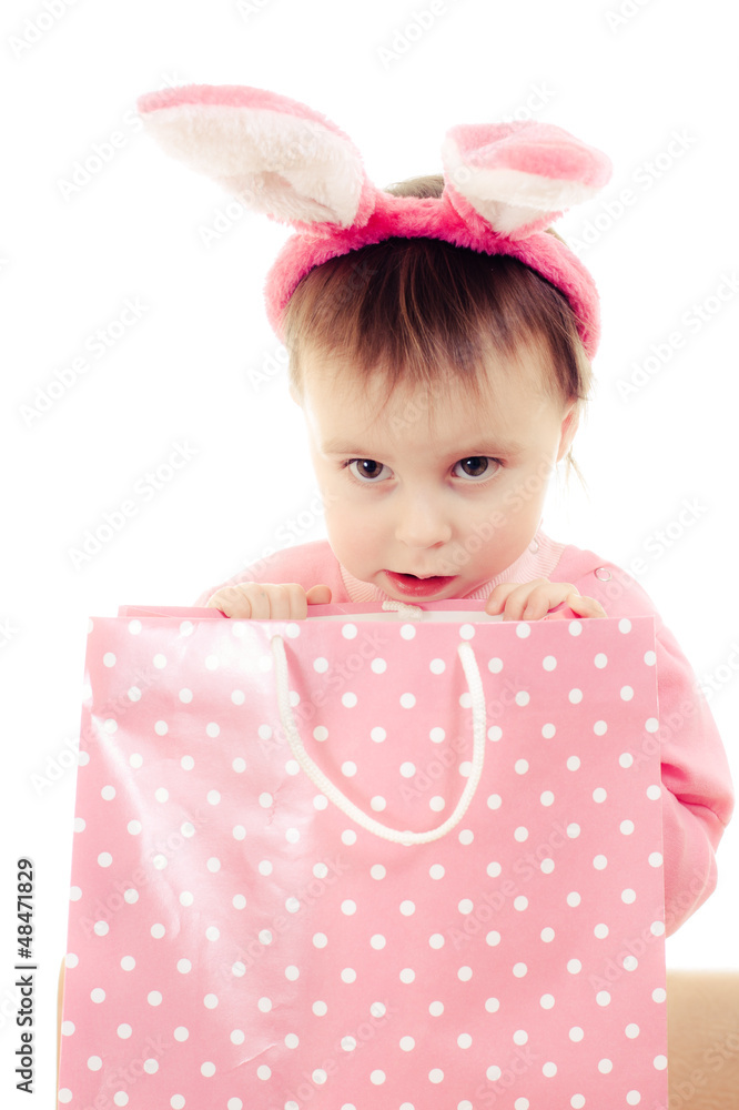 The little girl with pink ears bunny and bag. The little girl with pink ears bunny and bag.