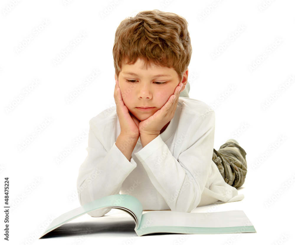 Child boy reading on floor isolated on white background Child boy reading on floor isolated on white background