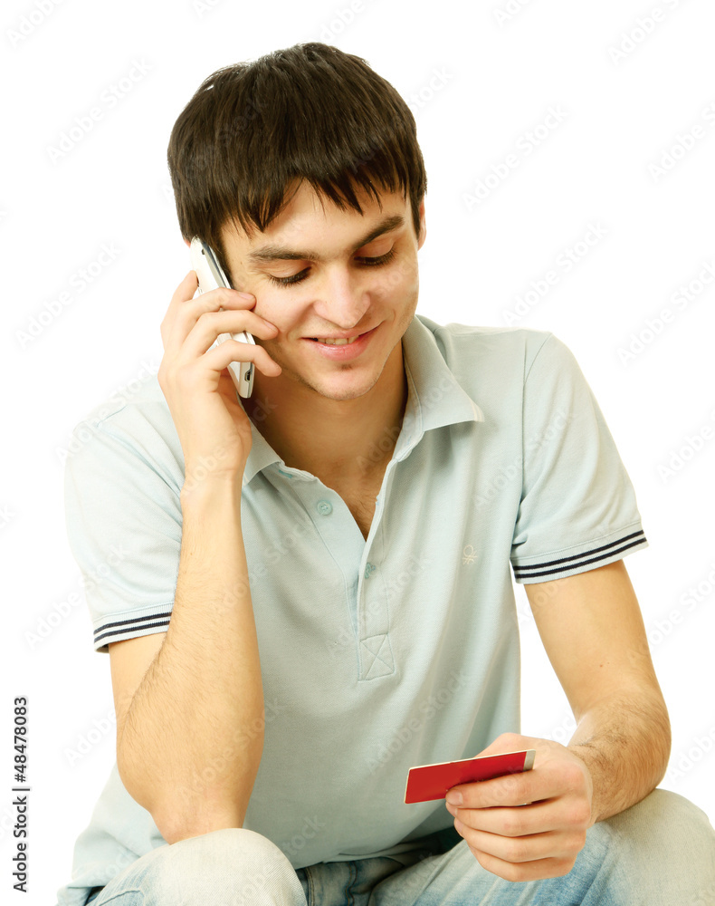 A young man with a mobile phone and a card A young man with a mobile phone and a card