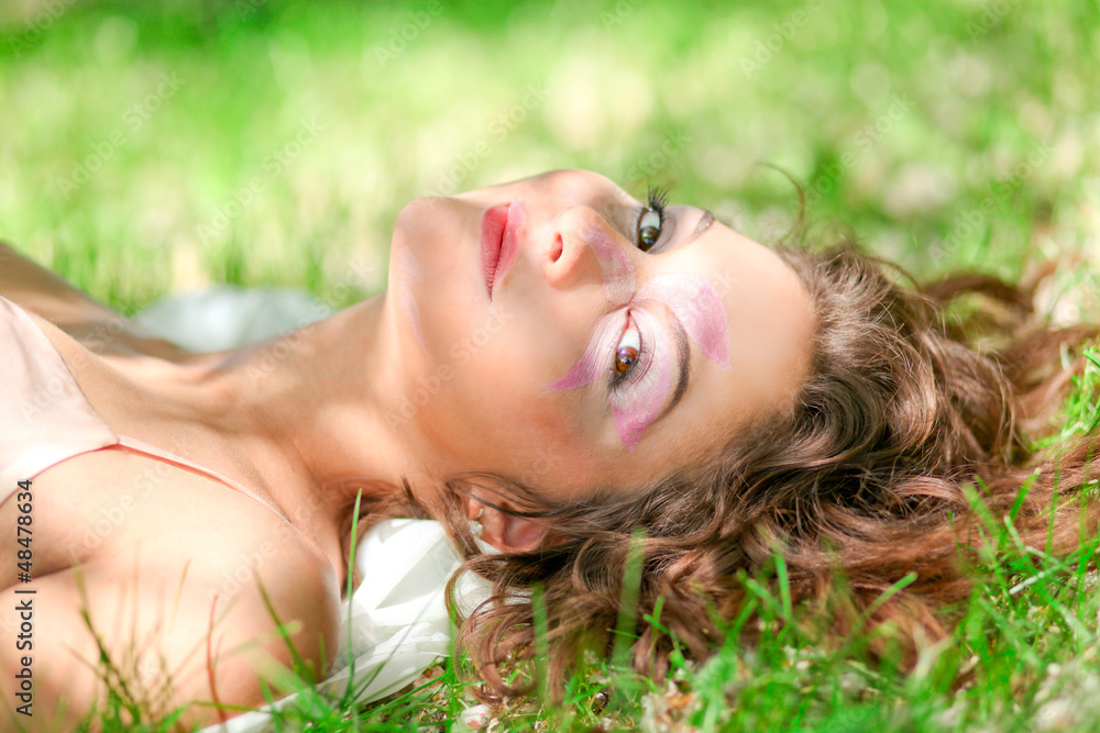pretty beautiful young girl in the evening sunshine laying pretty beautiful young girl in the evening sunshine laying