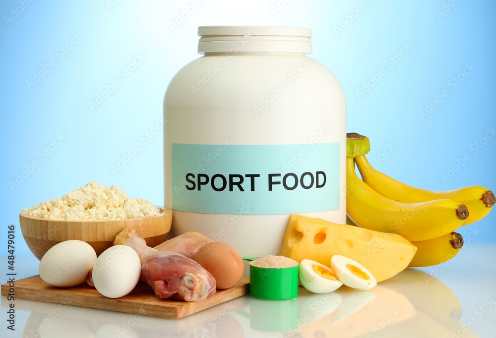 jar of protein powder and food with protein, on blue background jar of protein powder and food with protein, on blue background