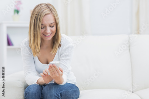 Happy woman with mobile phone at home