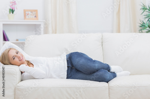 Portrait of casual woman lying on sofa