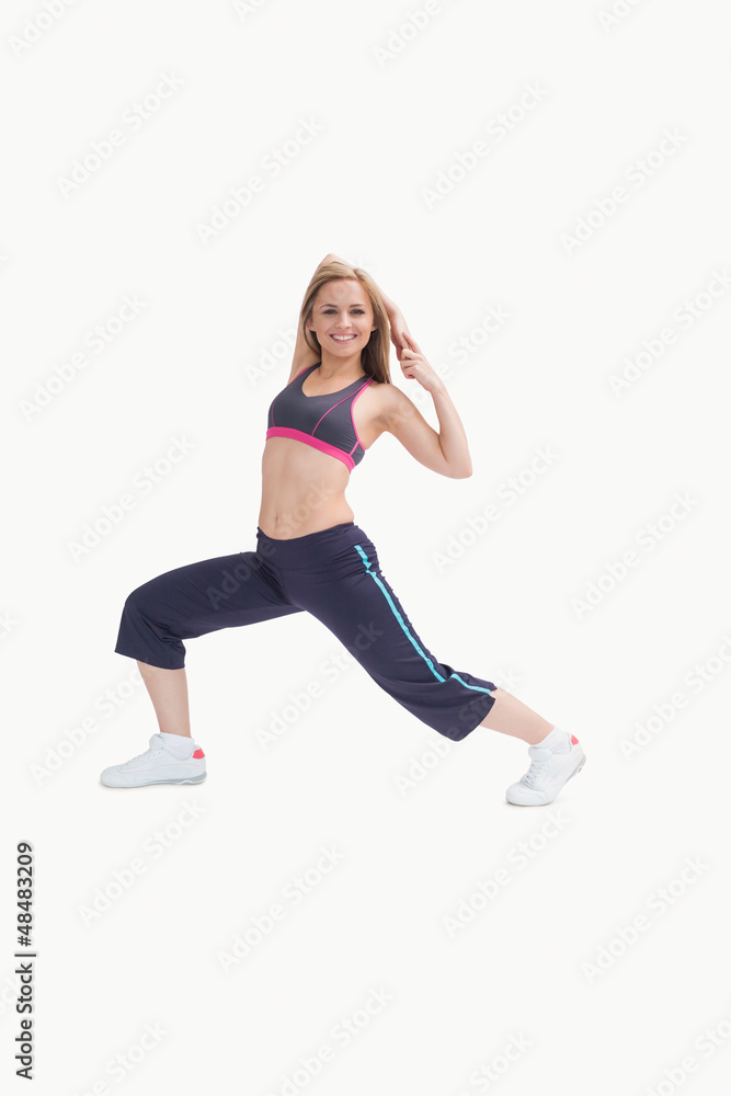 Portrait of happy young woman stretching body