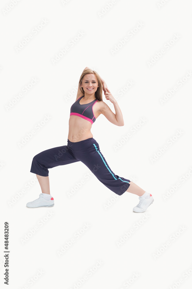 Portrait of happy young woman stretching body Portrait of happy young woman stretching body