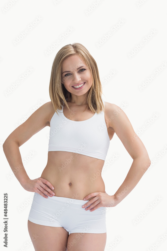 Portrait of happy woman in sportswear with hands on hip Portrait of happy woman in sportswear with hands on hip