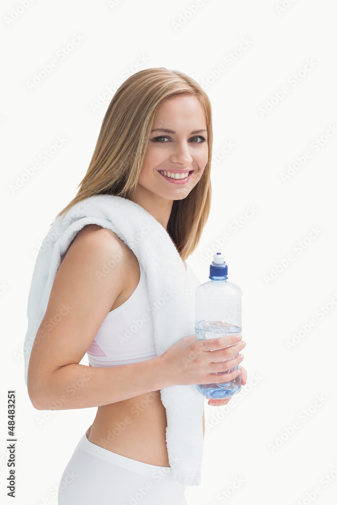 Portrait of smiling young woman with towel around neck holding w Portrait of smiling young woman with towel around neck holding w