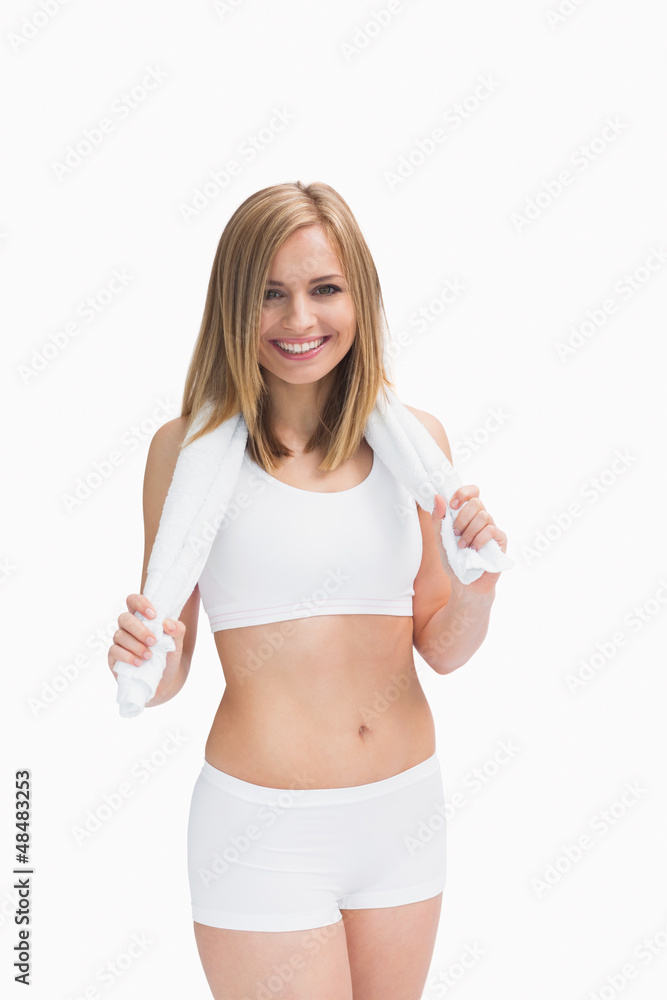 Portrait of happy woman in sportswear holding towel around neck Portrait of happy woman in sportswear holding towel around neck