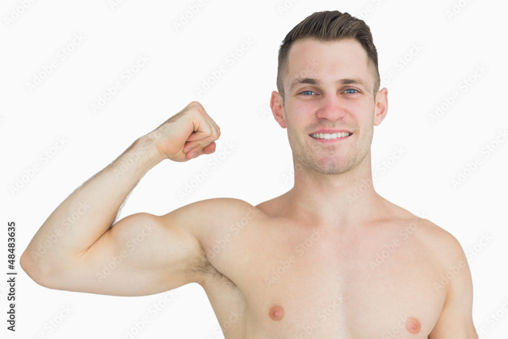Portrait of shirtless young man flexing muscles Portrait of shirtless young man flexing muscles