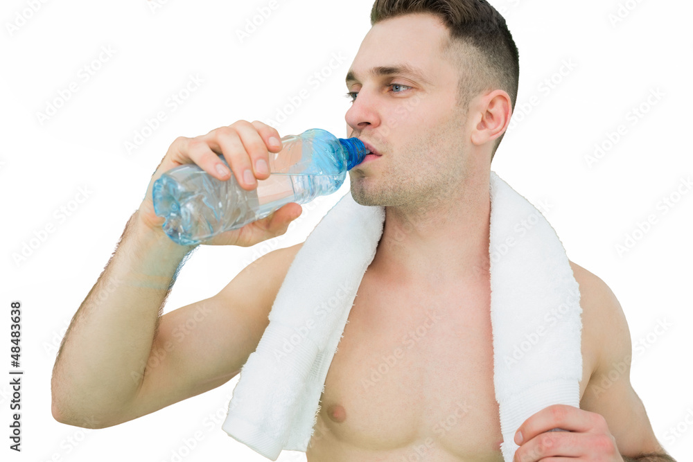 Shirtless man drinking water with towel around neck Shirtless man drinking water with towel around neck