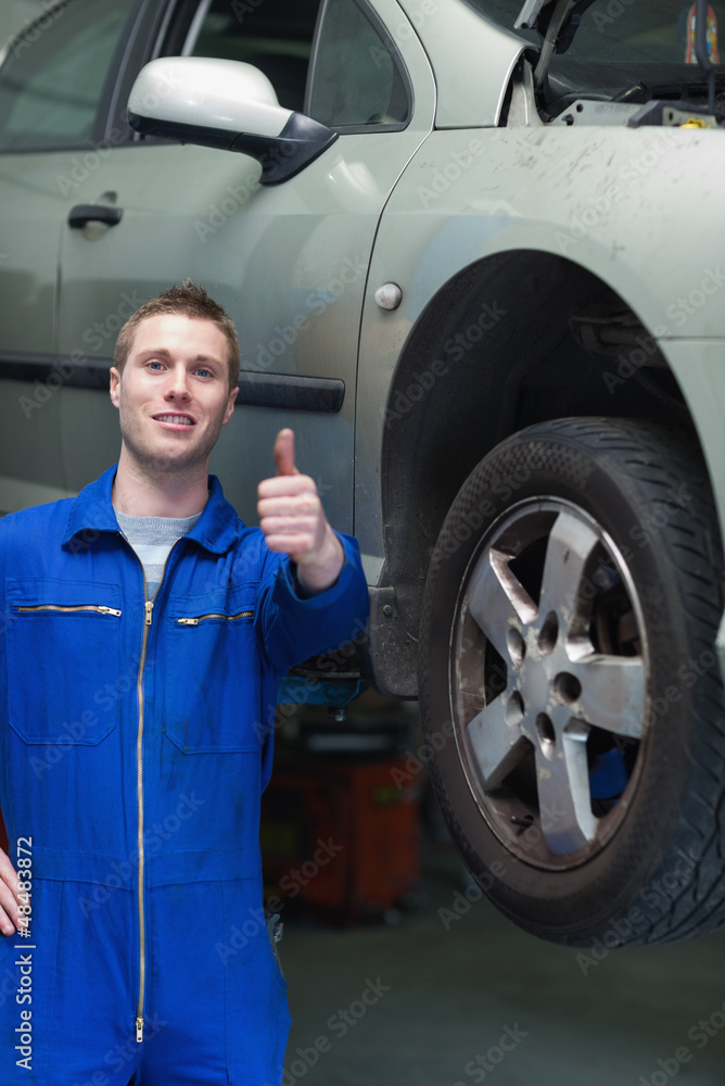 Car mechanic gesturing thumbs up Car mechanic gesturing thumbs up