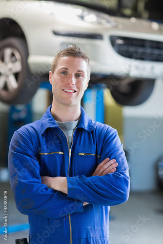 Confident  male mechanic smiling