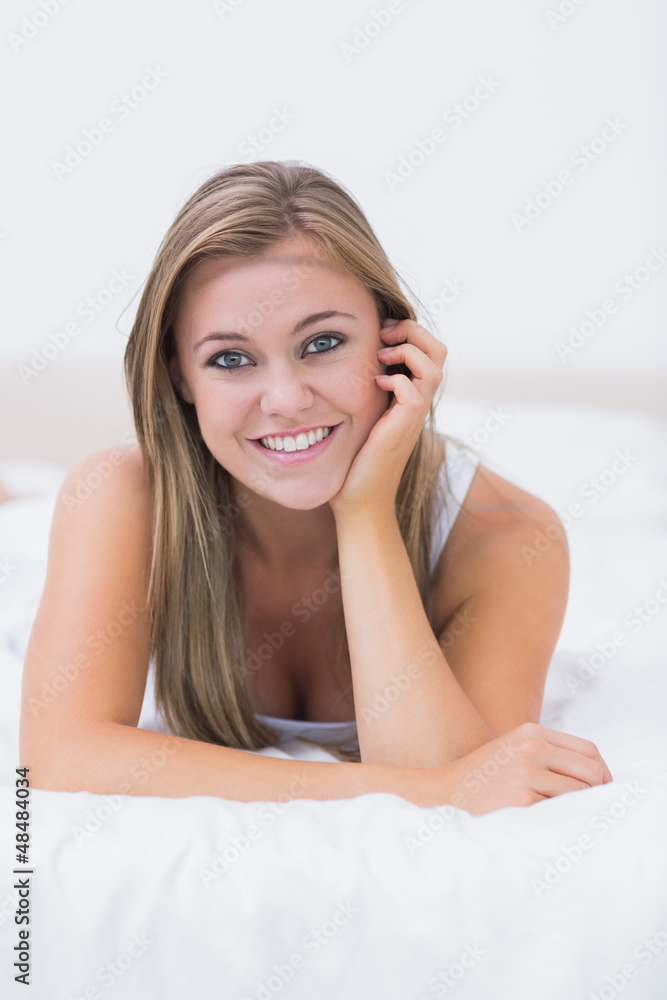 Blonde woman lying on her bed Blonde woman lying on her bed