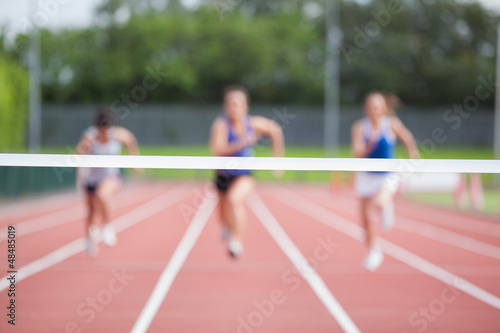 Athletes running towards finish line photo
