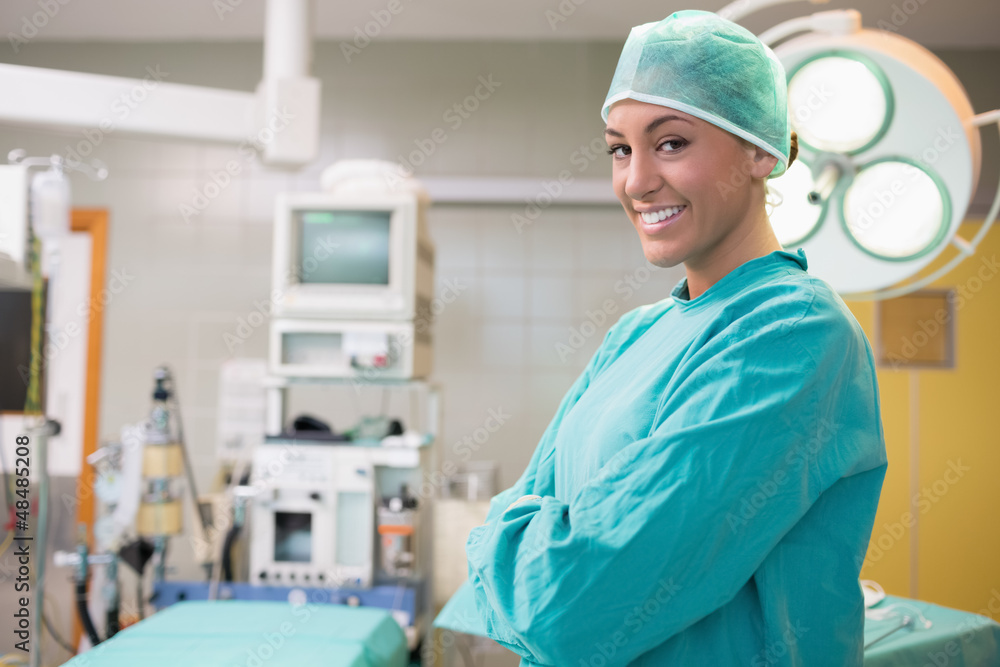Happy surgeon crossing her arms in an operation room Happy surgeon crossing her arms in an operation room