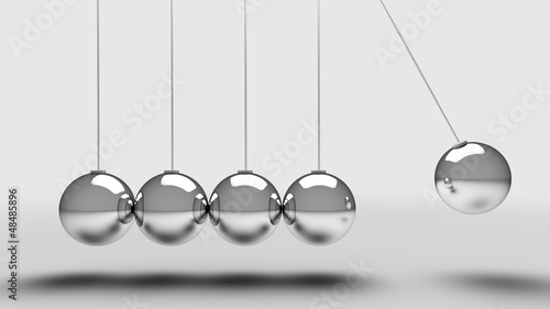 Balancing balls newtons cradle over light grey background