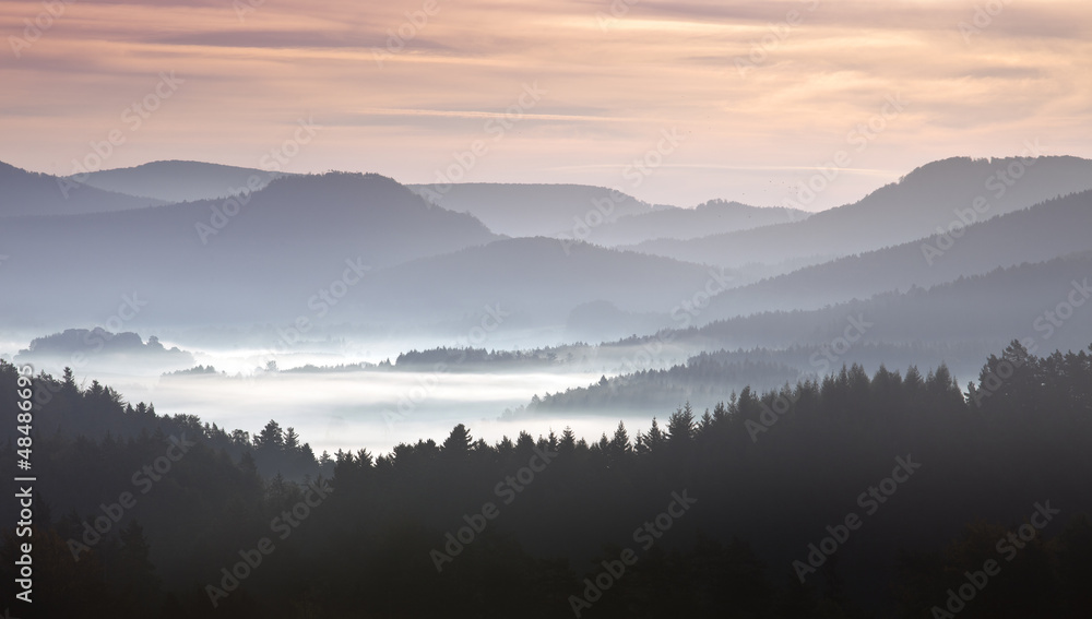 mist on hills in morning landscape