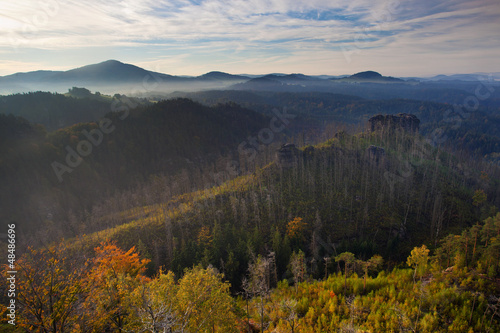 morning mist in rocky landscape with hills and forests at fall