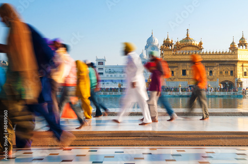 Group of Sikh pilgrims walking by the Golden Temple