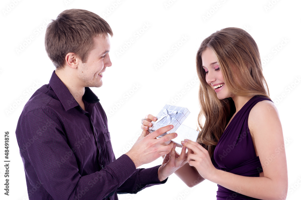 Man offering present to girlfriend on white background