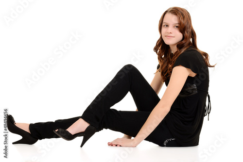 Teen girl in black sitting