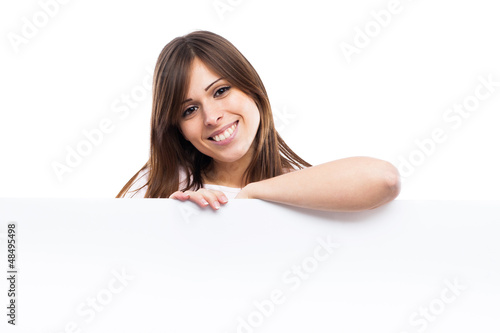 Portrait of a young woman with blank billboard