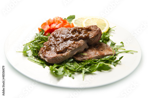 fresh grilled red meat with vegetables and sauce