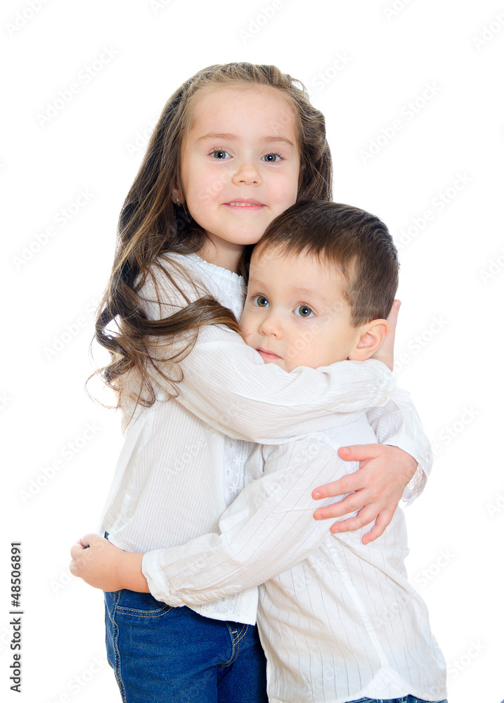 Little girl and boy hugging. Isolated on white Little girl and boy hugging. Isolated on white