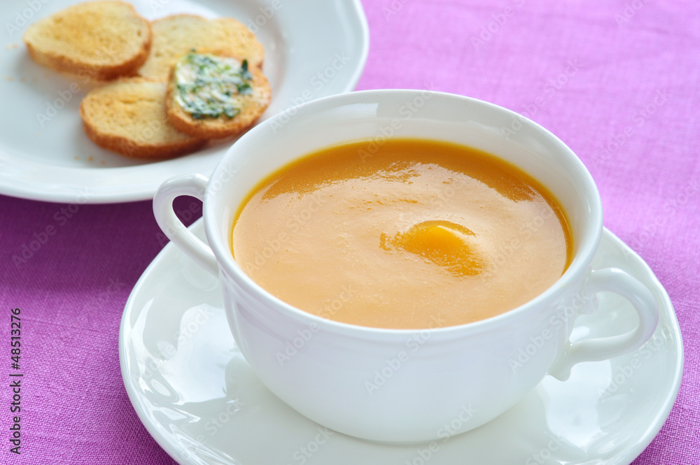 Close-up of roasted-pumpkin soup in a white bowl. Close-up of roasted-pumpkin soup in a white bowl.