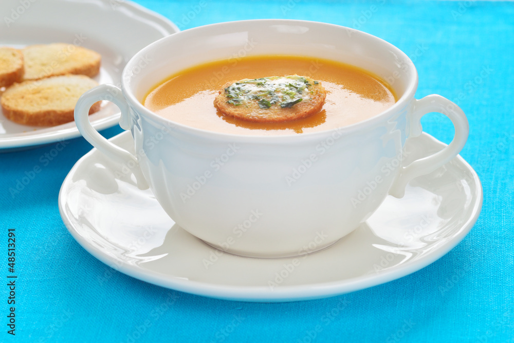 Close-up of roasted-pumpkin soup in a white bowl. Close-up of roasted-pumpkin soup in a white bowl.