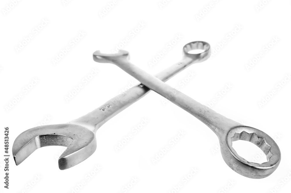 Two crossed wrenches on a white lie Two crossed wrenches on a white lie