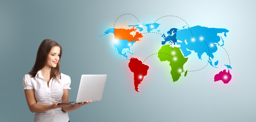Young woman holding a laptop and presenting colorful world map