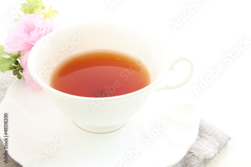 english black tea with flower on white background