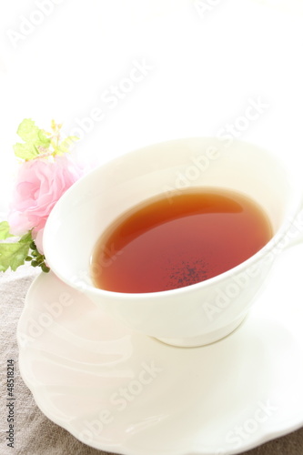 english black tea with flower on white background