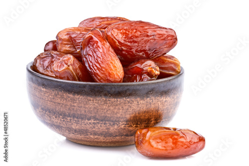 dried dates in brown cup isolated on white