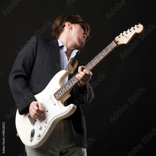 Handsome young man with electric guitar