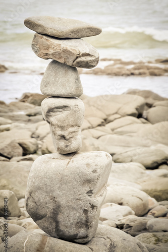 sepia toned rocks balanced on a beach