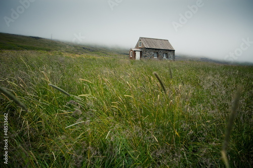 Bild auf Leinwand traditional small house in the middle of grassland